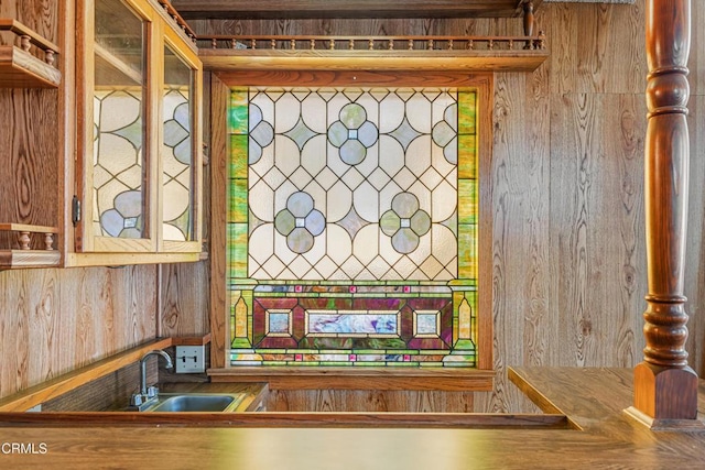 room details featuring wood walls and a sink