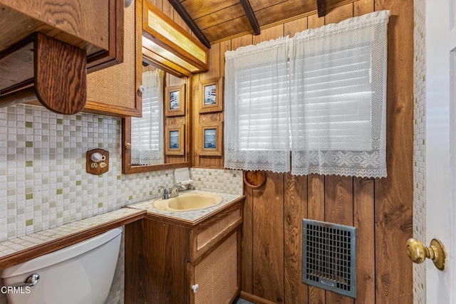 bathroom with toilet, wood ceiling, heating unit, vanity, and backsplash