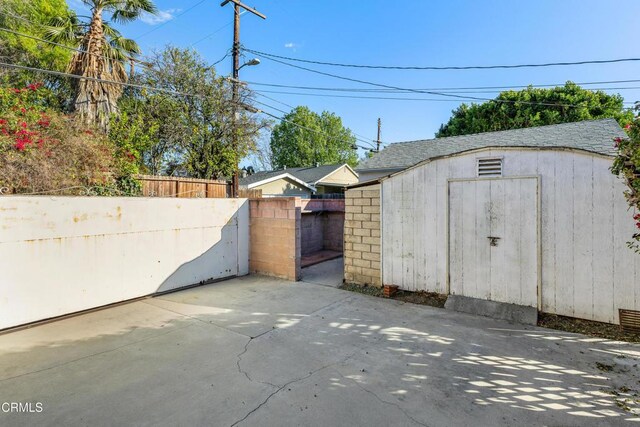 view of shed with fence