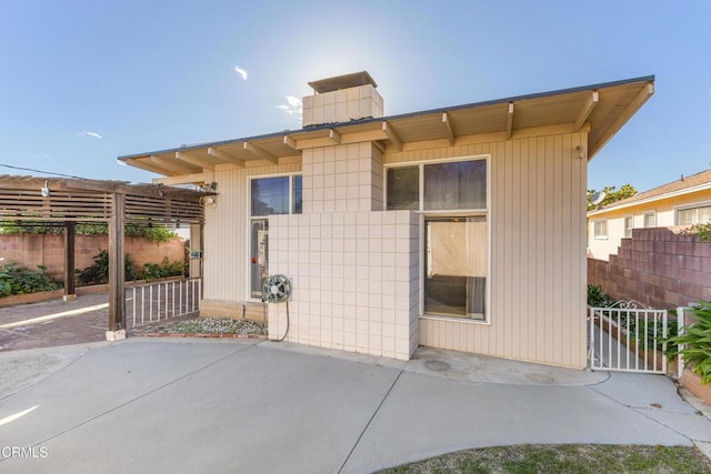 back of house with a patio and fence