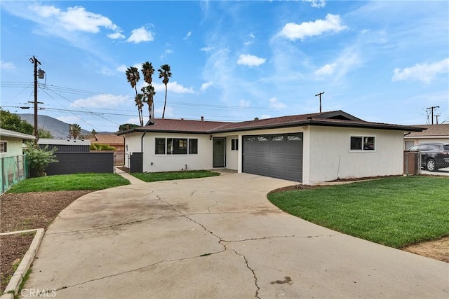 ranch-style house with an attached garage, driveway, fence, and stucco siding