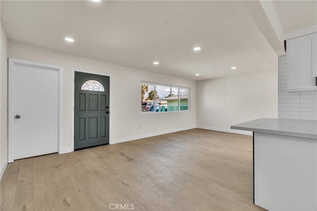 foyer entrance featuring baseboards, recessed lighting, and light wood-style floors