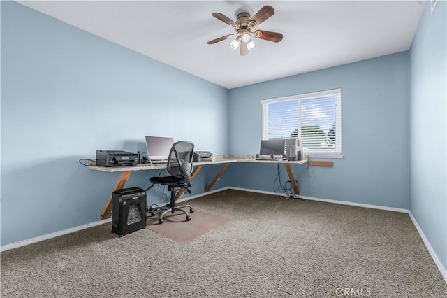 carpeted office featuring baseboards and a ceiling fan