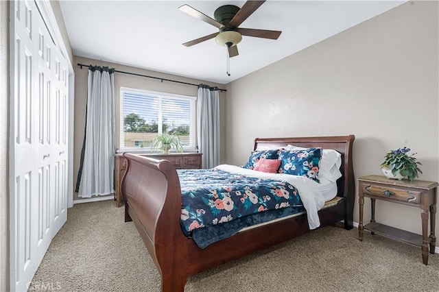 carpeted bedroom with ceiling fan and a closet