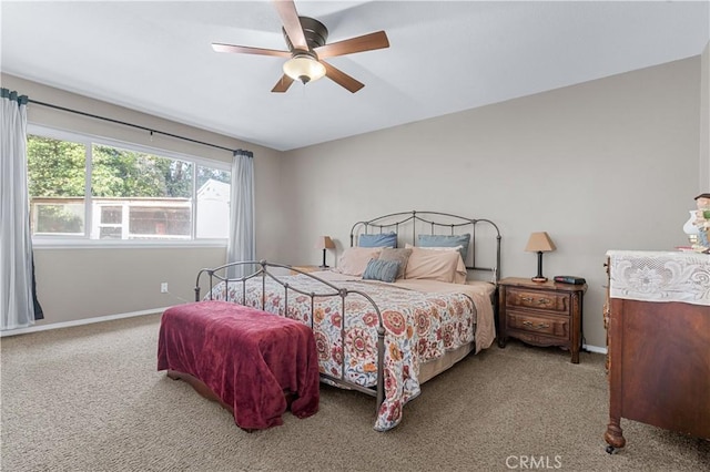 carpeted bedroom featuring ceiling fan and baseboards