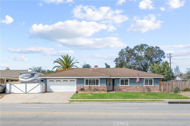 ranch-style home featuring a tile roof, brick siding, a gate, fence, and driveway