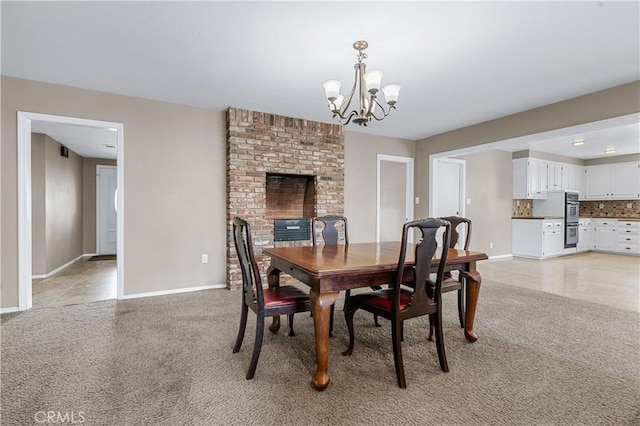 dining room with baseboards, a chandelier, and light colored carpet