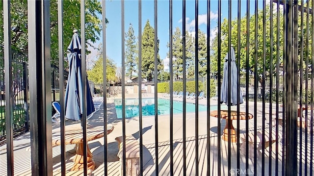 view of swimming pool featuring fence