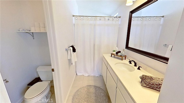 bathroom with baseboards, vanity, toilet, and tile patterned floors