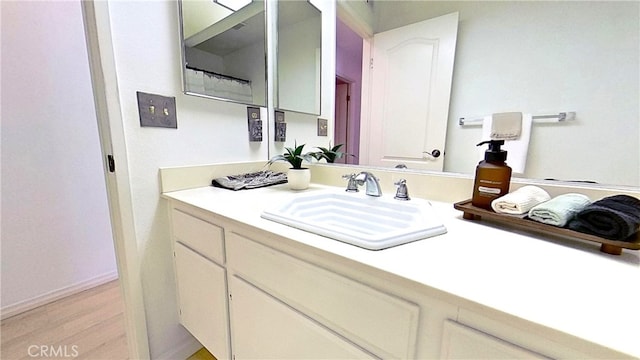 bathroom featuring wood finished floors and vanity