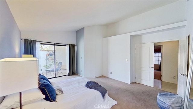 bedroom featuring lofted ceiling, access to outside, and carpet floors