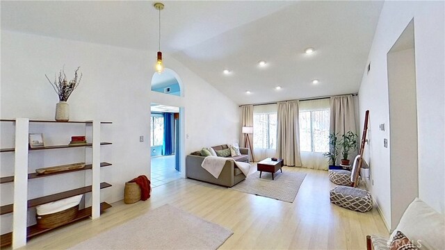 living room featuring recessed lighting, vaulted ceiling, and wood finished floors