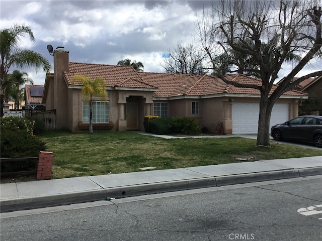 mediterranean / spanish home featuring a garage, driveway, stucco siding, a chimney, and a front yard