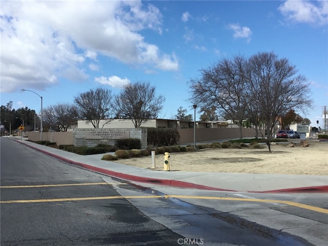 view of street with curbs, sidewalks, and street lights