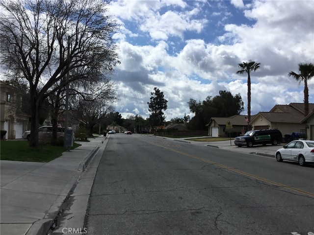 view of road with curbs, sidewalks, and a residential view