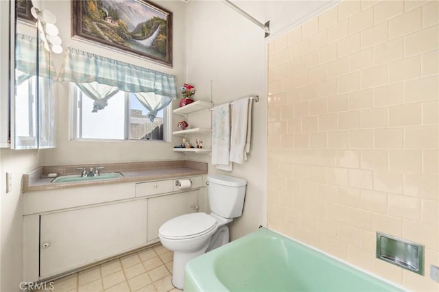 bathroom with vanity, toilet, and tile patterned floors