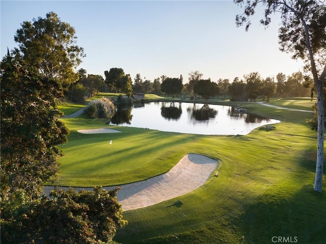 view of community featuring a water view, a yard, and golf course view