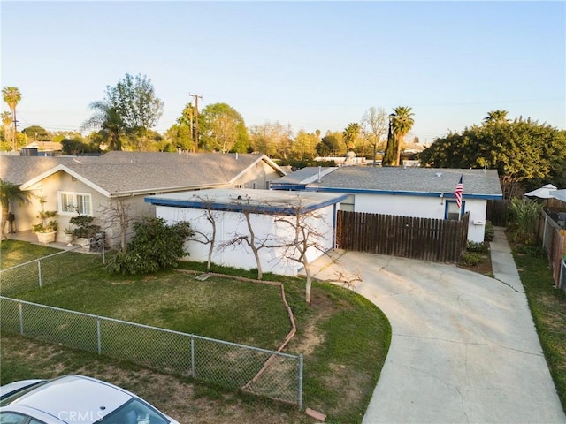 view of front facade featuring fence private yard and a front yard