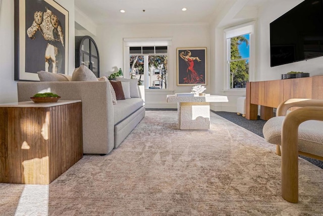 carpeted living room featuring recessed lighting, plenty of natural light, and crown molding