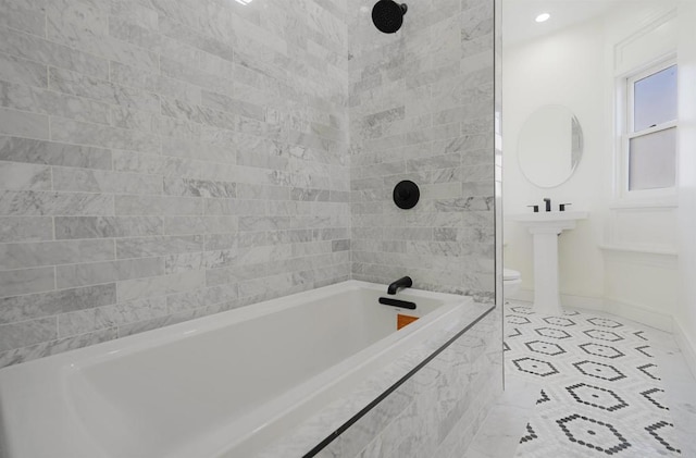 bathroom featuring shower / washtub combination, baseboards, and tile patterned floors