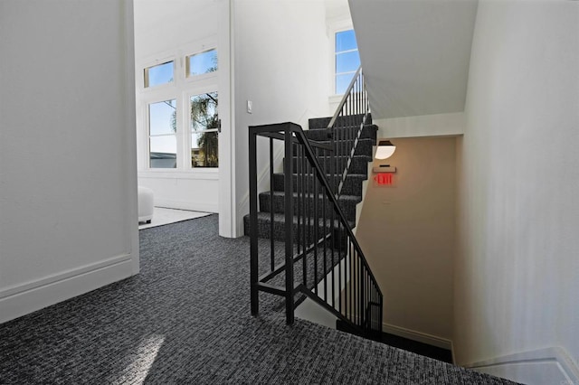 stairway with carpet floors and baseboards