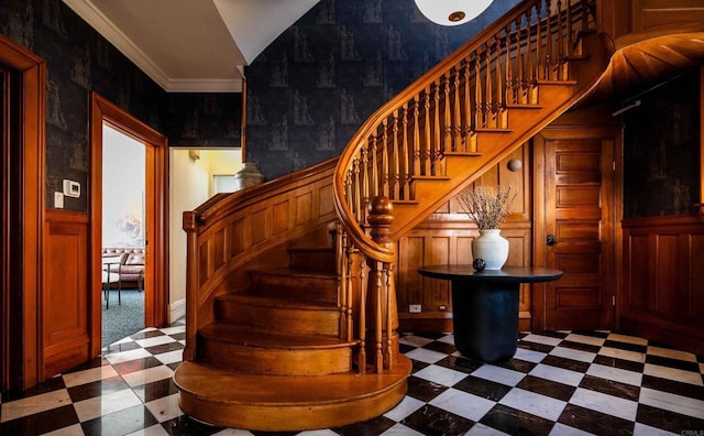 stairway featuring crown molding and tile patterned floors