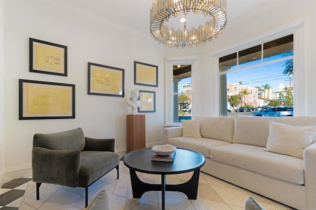 living area with a chandelier, ornamental molding, and baseboards