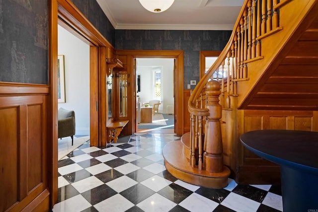 interior space with stairs, dark floors, and ornamental molding