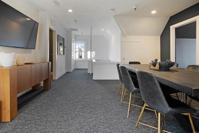 dining area featuring vaulted ceiling, dark colored carpet, baseboards, and recessed lighting