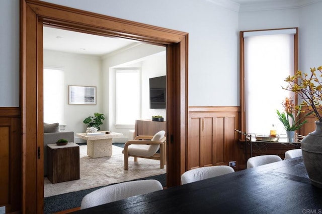 dining space with crown molding and carpet flooring