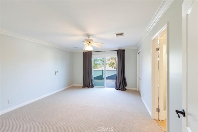 unfurnished room with light carpet, ornamental molding, a ceiling fan, and baseboards