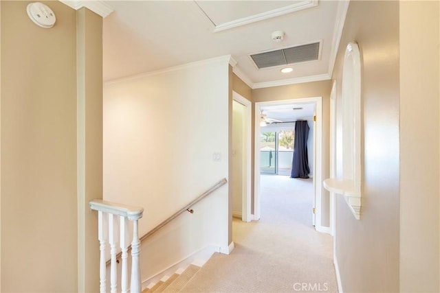 hallway with visible vents, ornamental molding, light carpet, an upstairs landing, and baseboards