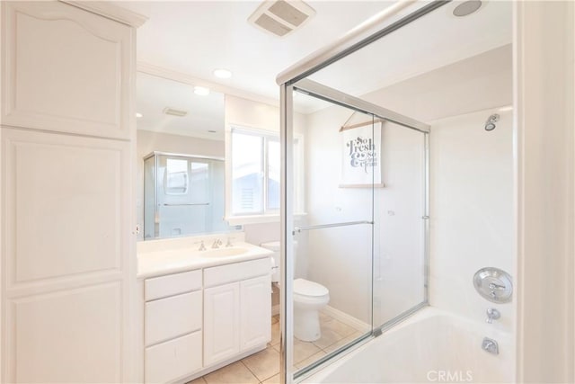 full bathroom with toilet, vanity, visible vents, combined bath / shower with glass door, and tile patterned floors