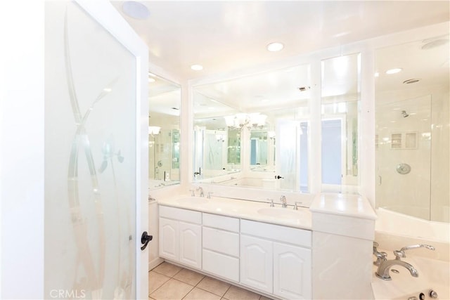 bathroom featuring a tub, tile patterned flooring, a sink, and double vanity