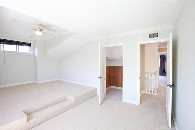 bonus room with light carpet, baseboards, visible vents, and a ceiling fan