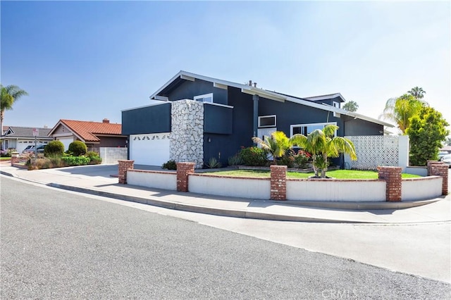 mid-century modern home featuring driveway and stucco siding