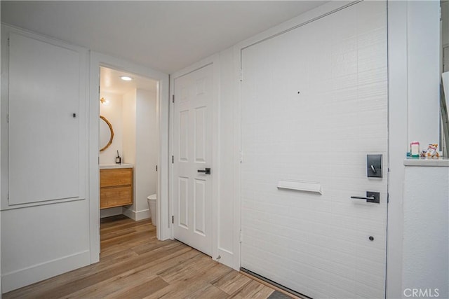 interior space featuring light wood-style flooring and baseboards