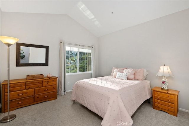 bedroom featuring carpet floors, baseboards, and vaulted ceiling