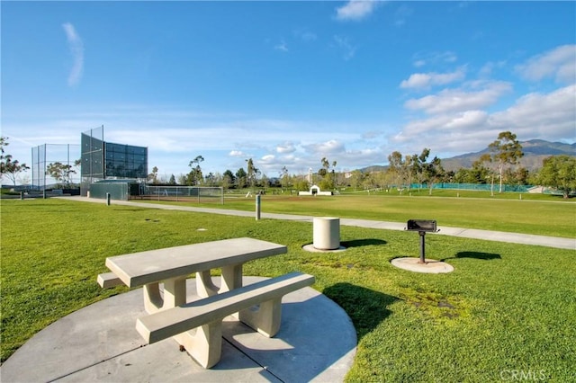 view of community with a lawn and a mountain view