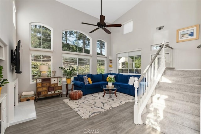 interior space with a ceiling fan, a wealth of natural light, visible vents, and vaulted ceiling