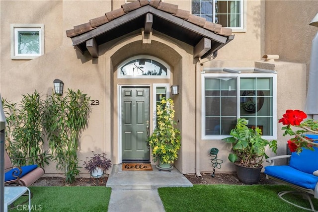 property entrance with stucco siding