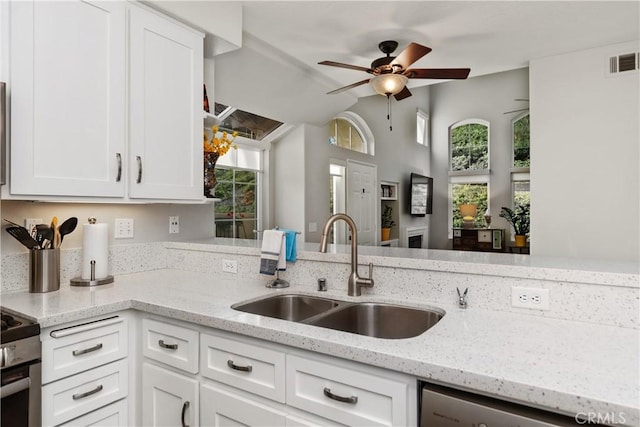 kitchen featuring visible vents, white cabinets, ceiling fan, stainless steel appliances, and a sink