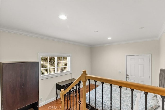 interior space featuring recessed lighting, baseboards, wood finished floors, and ornamental molding