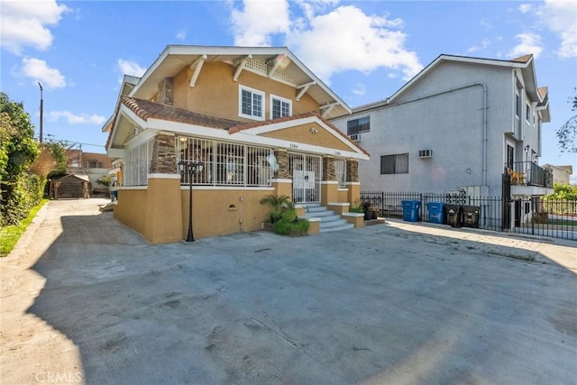 view of front of home with fence and stucco siding