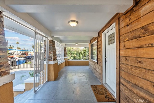 hall with beamed ceiling