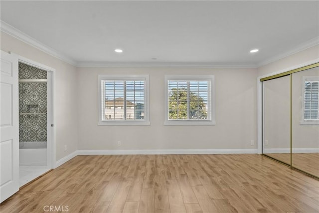 unfurnished bedroom with baseboards, light wood-style floors, and ornamental molding