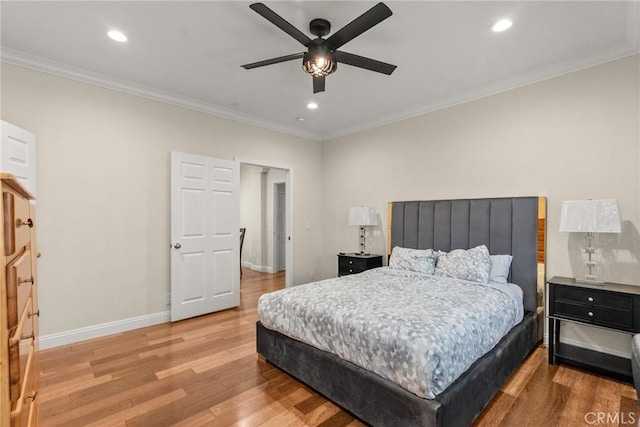 bedroom with recessed lighting, ornamental molding, baseboards, and wood finished floors