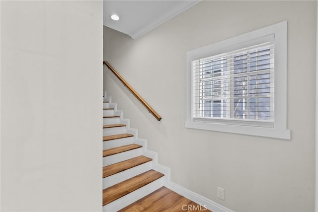 staircase with recessed lighting, wood finished floors, and baseboards