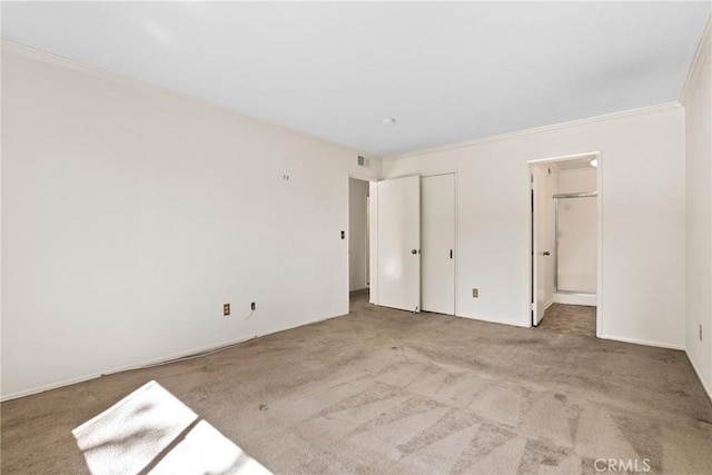 unfurnished bedroom with carpet flooring, visible vents, and crown molding