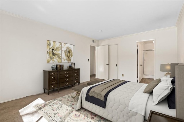 bedroom featuring visible vents, ornamental molding, carpet flooring, and ensuite bathroom